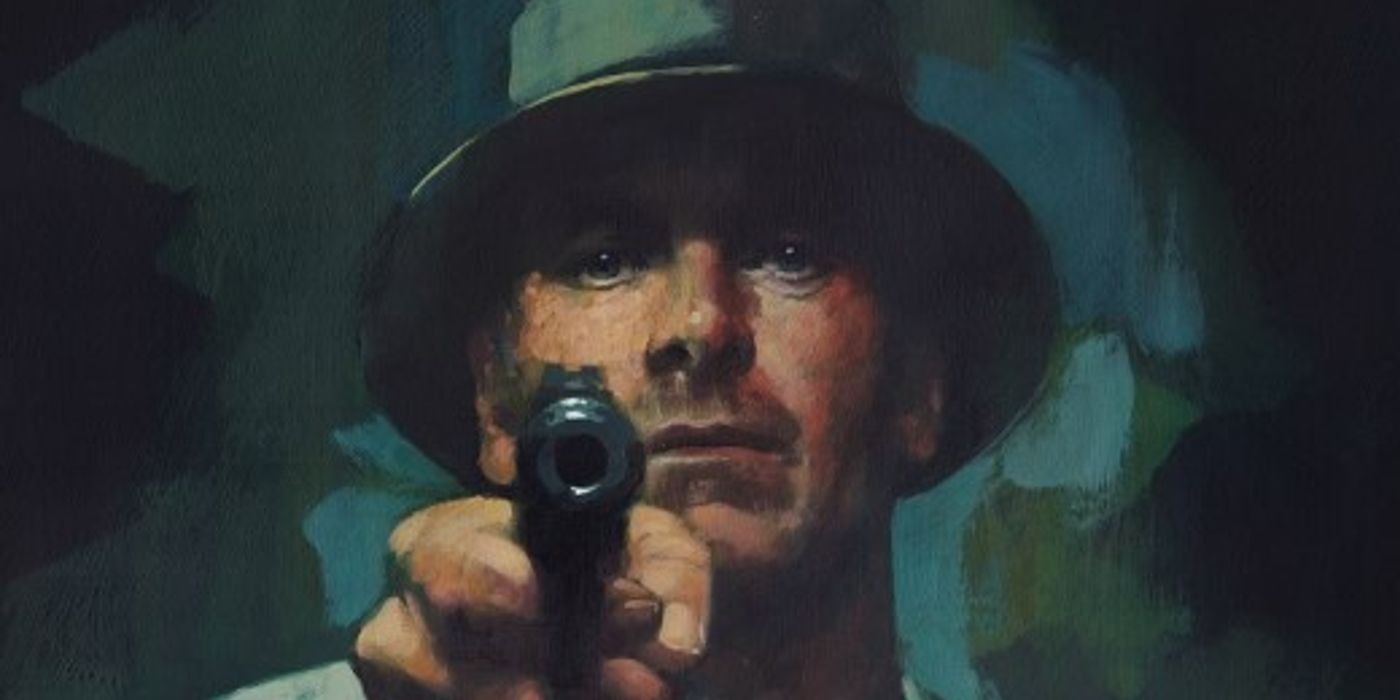 Michael Fassbender menodongkan pistol ke poster The Killer